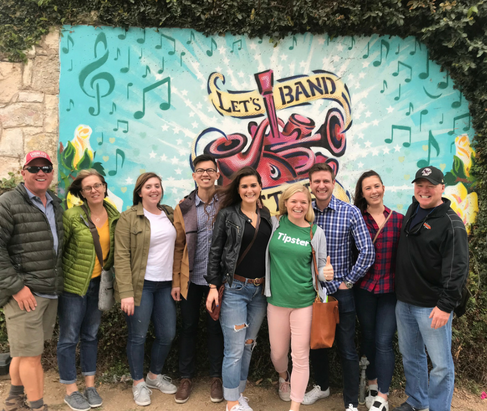 Free walking tour in Austin posing in front of "Band Together" mural