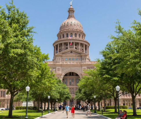 Texas State Capital with two rows of trees lining the sidewalk