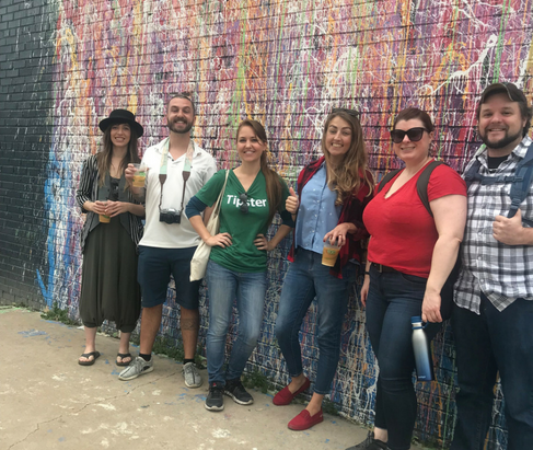 Group photo in front of dripping colors Austin mural