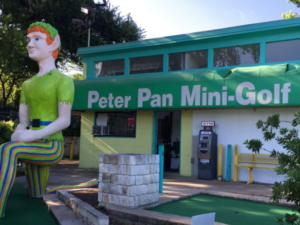Front entrance to Peter Pan Mini Golf with a giant statue of Peter Pan in front