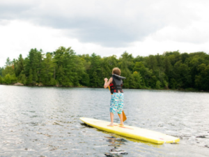 kids stand up paddle boarding in Lady Bird Lake